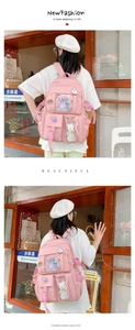 Pink student backpack with transparent window pocket and cute plush doll decoration
