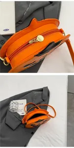 Detail of creative orange pumpkin handbag showing high-quality zipper and stylish design