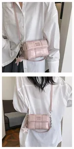 Detailed views of a pink woven patent leather crossbody bag with star charm and chain strap