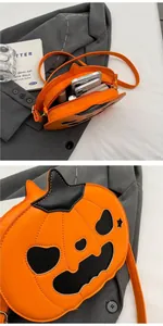 Close-up of Halloween pumpkin crossbody bag with leather patchwork and zipper detail