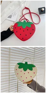 Close-up of strawberry shaped crossbody bags in red and cream white with seed patterns