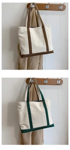 Detail of large canvas tote bags in white with brown and green contrast straps