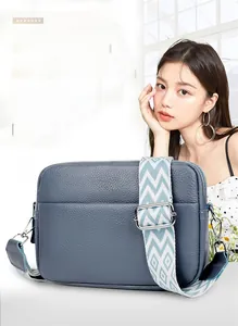 Blue lychee pattern leather crossbody bag with geometric wide fabric shoulder strap detail