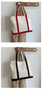 Detail of red and black trim contrast on canvas tote bags with thick durable texture