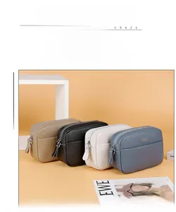 Detail view of colorful camera bags in genuine leather with multiple zip compartments