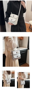 Detail of vintage small square crossbody bags in glossy white and metallic silver finish