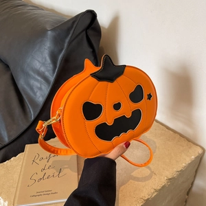 Chic Halloween pumpkin shoulder bag in orange PU leather with Jack-o'-lantern face detail