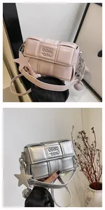 Detail of woven square crossbody bags in pink and silver with chic star charms