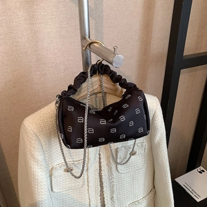 Chic black rhinestone boston bag with chain strap and pleated handle on neutral background