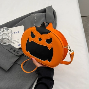 Fashionable Halloween pumpkin crossbody bag in orange leather with spooky face detail