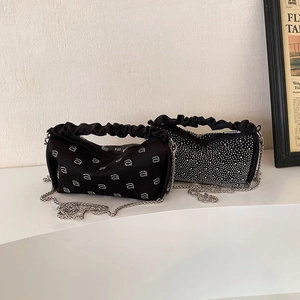 Elegant black velvet handbag set with shimmering rhinestones and stylish chain straps
