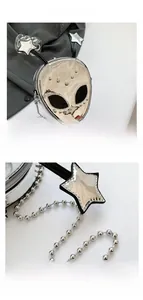 Detail of silver alien cross-body bag featuring star-topped antennas and ball chain strap