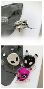 Detail showing metallic alien crossbody bags in silver, black and purple with ball chains