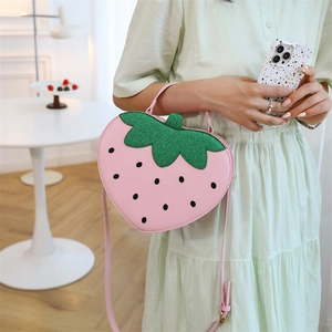 Pink strawberry-shaped crossbody bag made of PU leather with green sequin leaf details