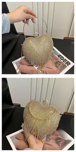 Macro view of golden heart-shaped evening bag featuring sparkling rhinestone fringes