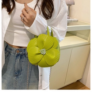 Close-up of light green floral petal handbag with white bead detail and silver chain