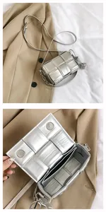 Detail view of woven leather bag with magnetic closure and silver metallic finish
