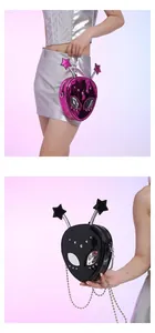 Detail of alien-shaped crossbody bag with star-tipped antennas and metallic studs