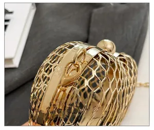 Detailed close-up of golden hollow honeycomb metallic evening clutch with chain strap