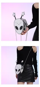 Detailed macro view of silver metallic alien-shaped crossbody bag with star antennas