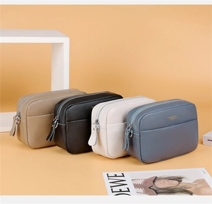 Macro detail of colorful leather camera bags with pebble grain texture and dual zippers