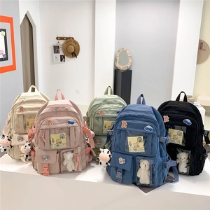 Waterproof nylon school backpacks in five colors with cute bear charms and rainbow patches