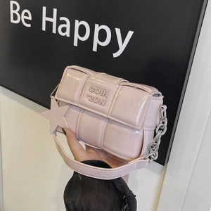 Pink woven leather square bag with silver chain strap and star charm accessory