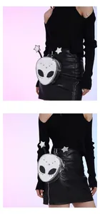 Detailed view of silver alien-shaped crossbody bag with star antennas and metallic finish