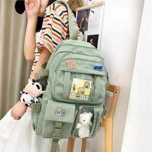 Light green multi-pocket school backpack with cute cow plush charm for students