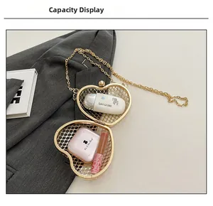 Detail view of golden heart hollow bag showing internal capacity with makeup items