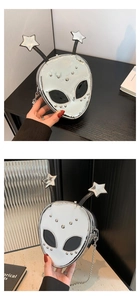 Macro shot of silver metallic alien bag with star antennas and polished chain detail