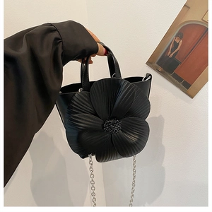 Chic black PU leather handbag with a large 3D flower accent and silver chain strap