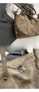 Close-up of silver metal zipper and matte texture on retro coffee Boston handbag