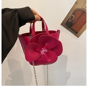 Fuchsia PU leather handbag featuring a large 3D flower and silver chain shoulder strap
