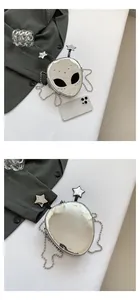 Front and back detail of silver alien shaped crossbody bag with metallic chain and stars