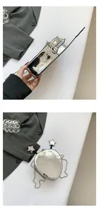 Detail of alien-shaped silver mirror crossbody bag with star-tipped antenna and metal chain