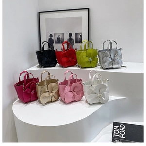 Detail display of flower petal bucket bags in eight colors with chain straps