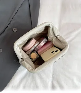 Detail of spacious interior showing storage for makeup and phone in cloud-shaped bag