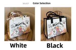 Close-up of canvas tote bag with artistic animal graffiti in white and black colors