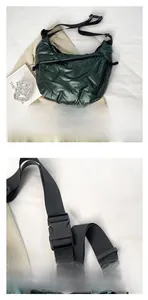 Detail view of large dark green quilted puffer tote bag with adjustable shoulder strap and buckle