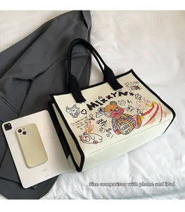 Detailed size comparison of canvas tote bag with graffiti showing iPad and phone storage