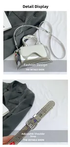 Detail view of silver crossbody bag featuring adjustable leather strap and metal hardware