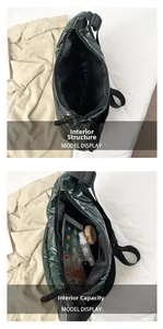 Detailed interior view showing large capacity and drawstring closure of quilted puffer bag