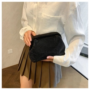 Close-up of black rhinestone evening clutch bag with sparkling beaded texture