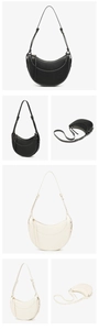 Detail view of crescent saddle bags in black and beige with adjustable shoulder straps