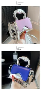 Close-up of metallic mini bags in purple and blue with artistic silver handles