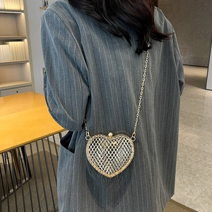 Minimalist heart-shaped gold metal mesh crossbody bag with delicate chain strap