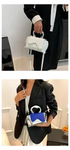 Modern mini handbag with unique wavy flap and metallic handle for chic crossbody styling