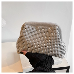 Close-up of light gray cloud clutch featuring silver round rivet grid decoration