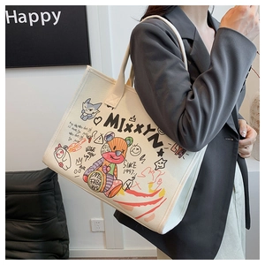 Chic cream canvas tote bag with colorful cartoon graffiti shown in an urban lifestyle setting